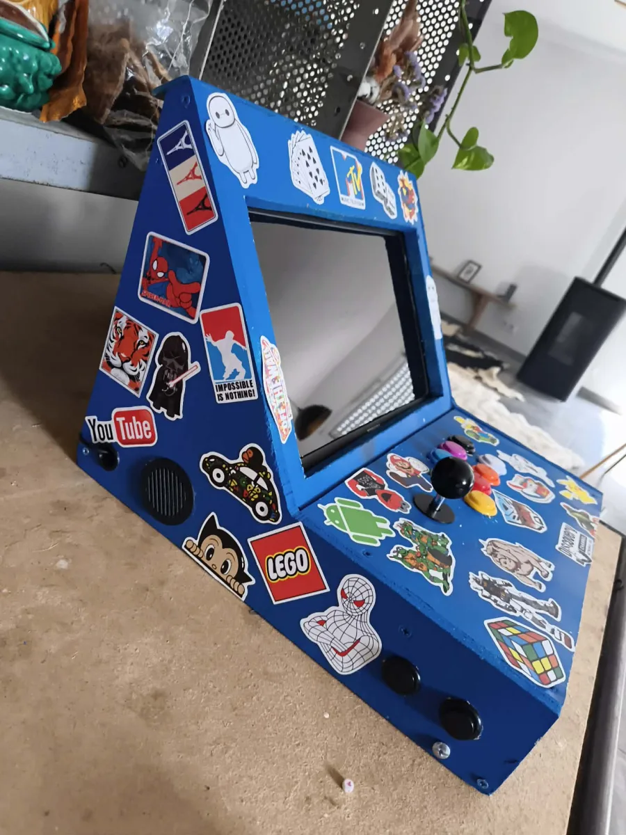 Final view of the blue arcade cabinet covered with stickers